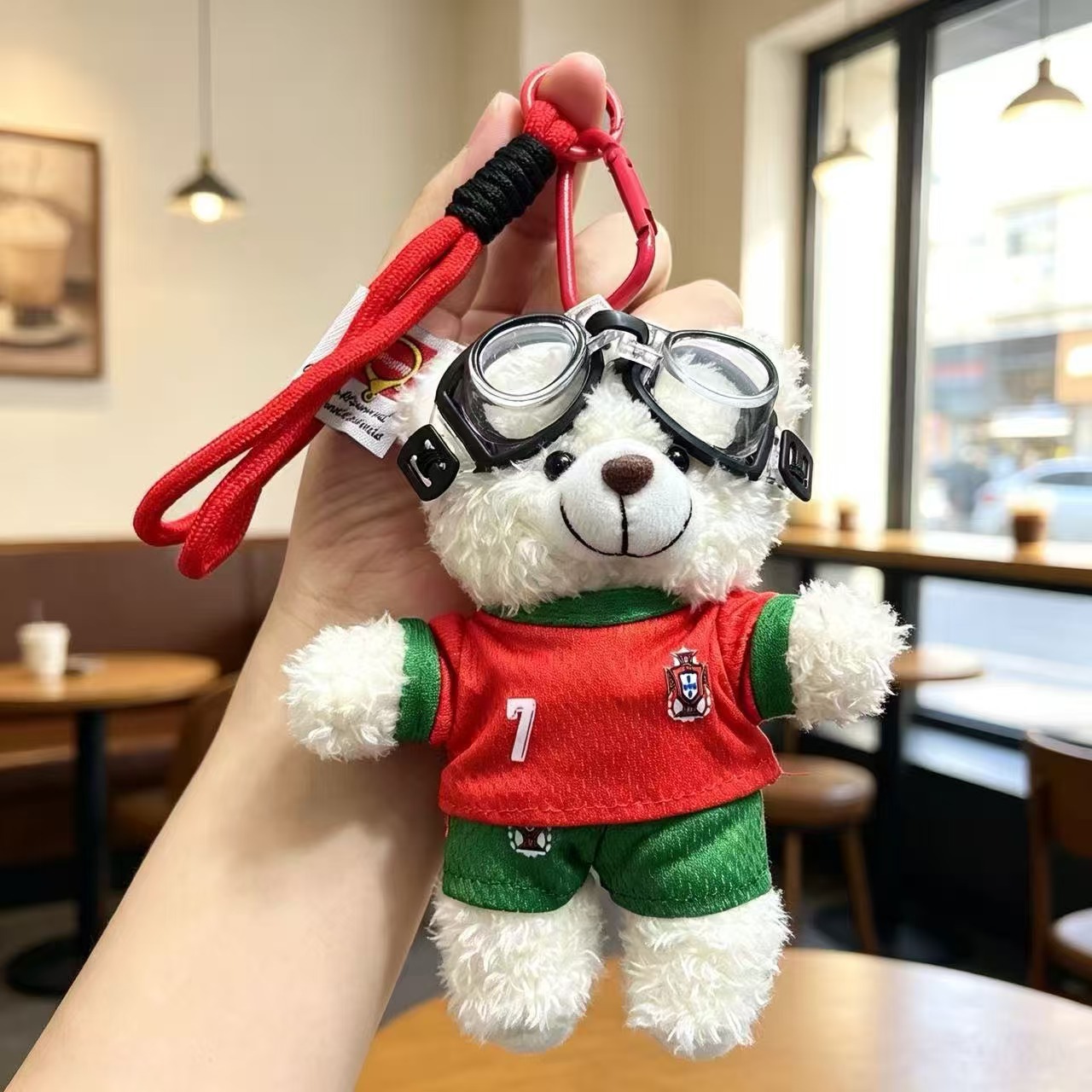 White plush bear keychain with goggles and red kit
