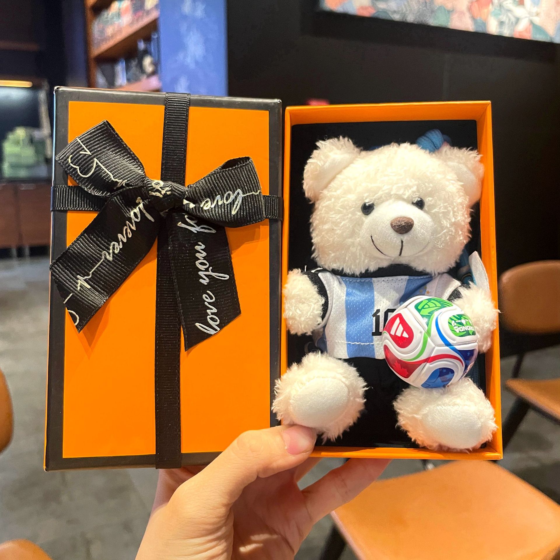 Gift-box plush bear keychain with striped shirt and football